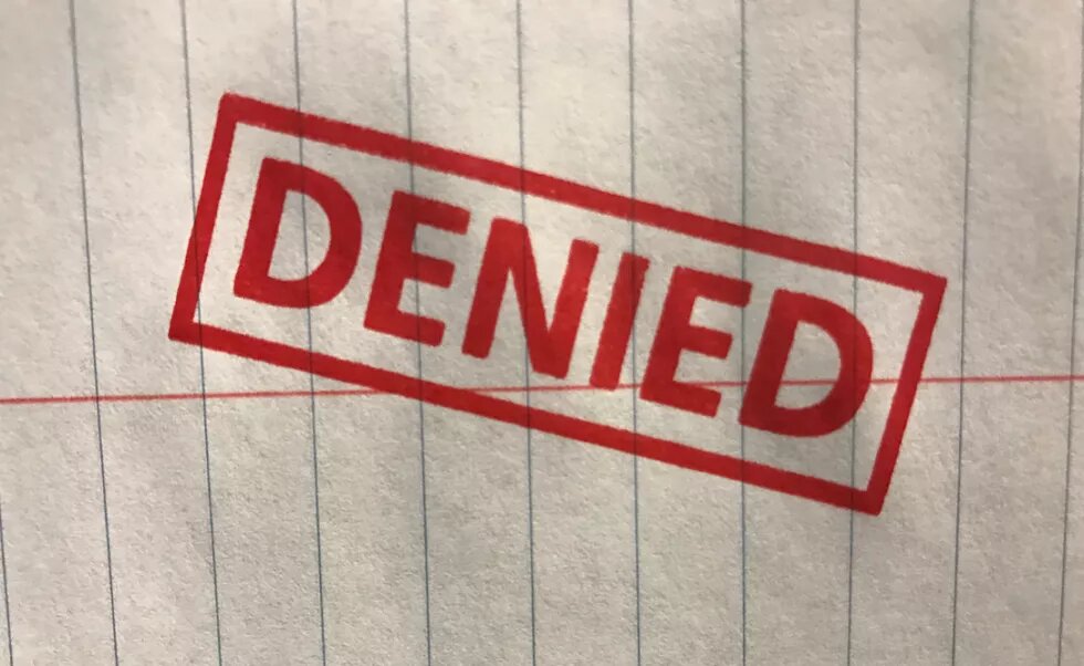 "denied" stamp on paper