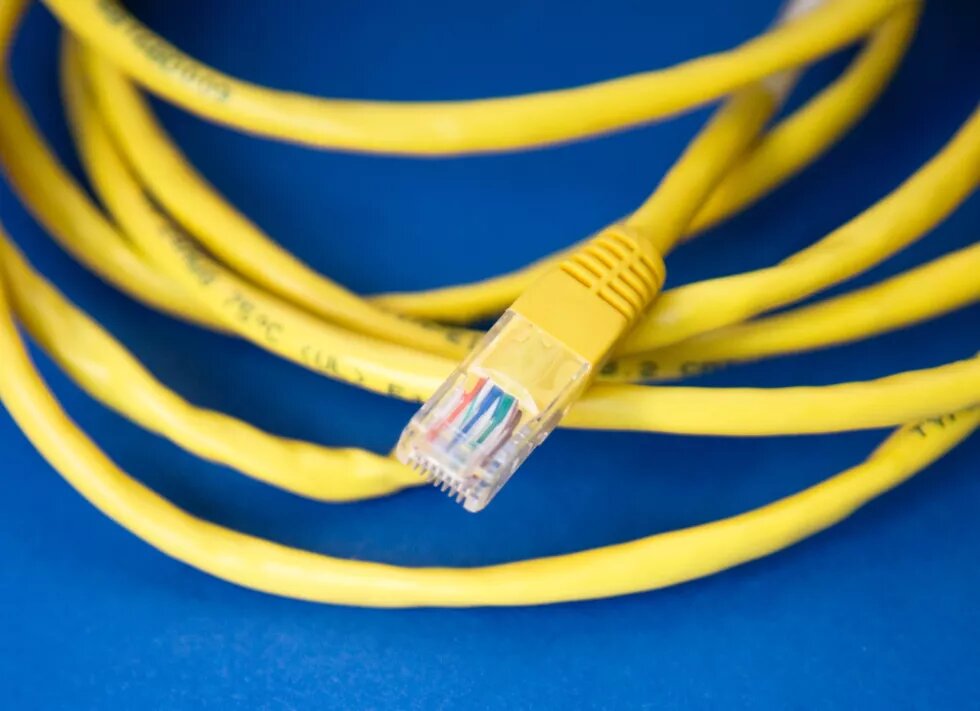 yellow LAN cable on blue background