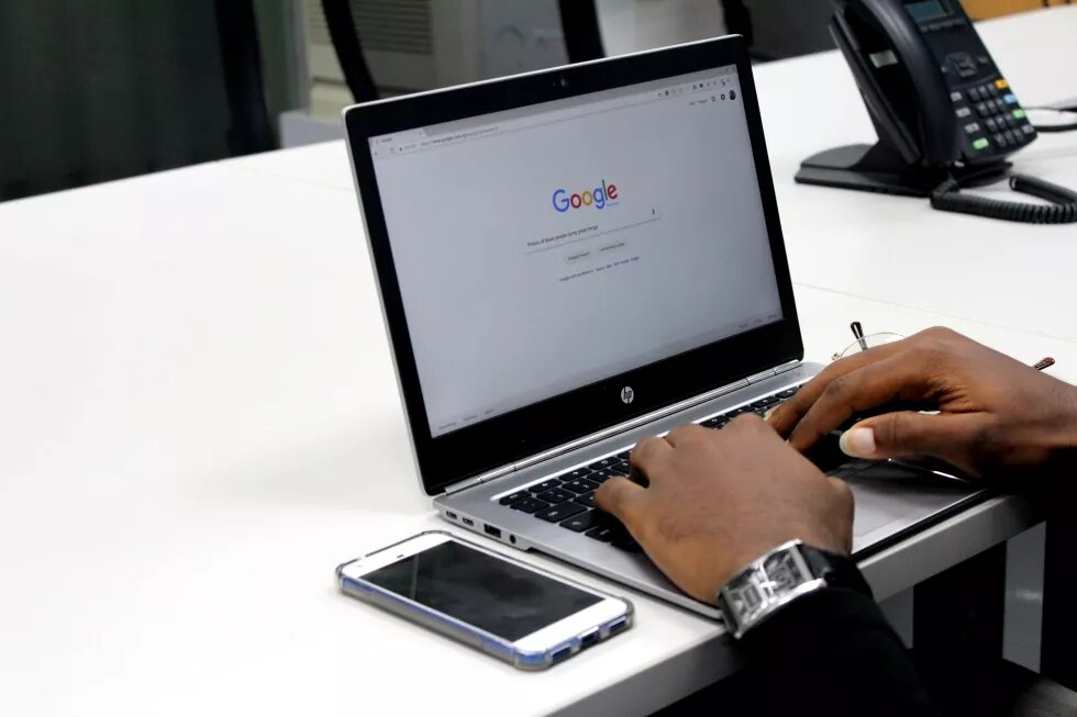 PoC/black persons hands typing on laptop