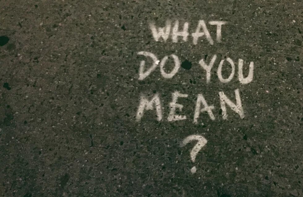 the words "what do you mean?" written on concrete floor