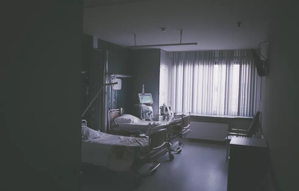 hospital room with beds in dark grey tones