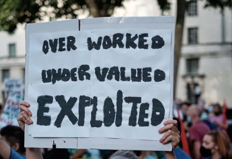 demonstration poster "over worked under valued exploited"